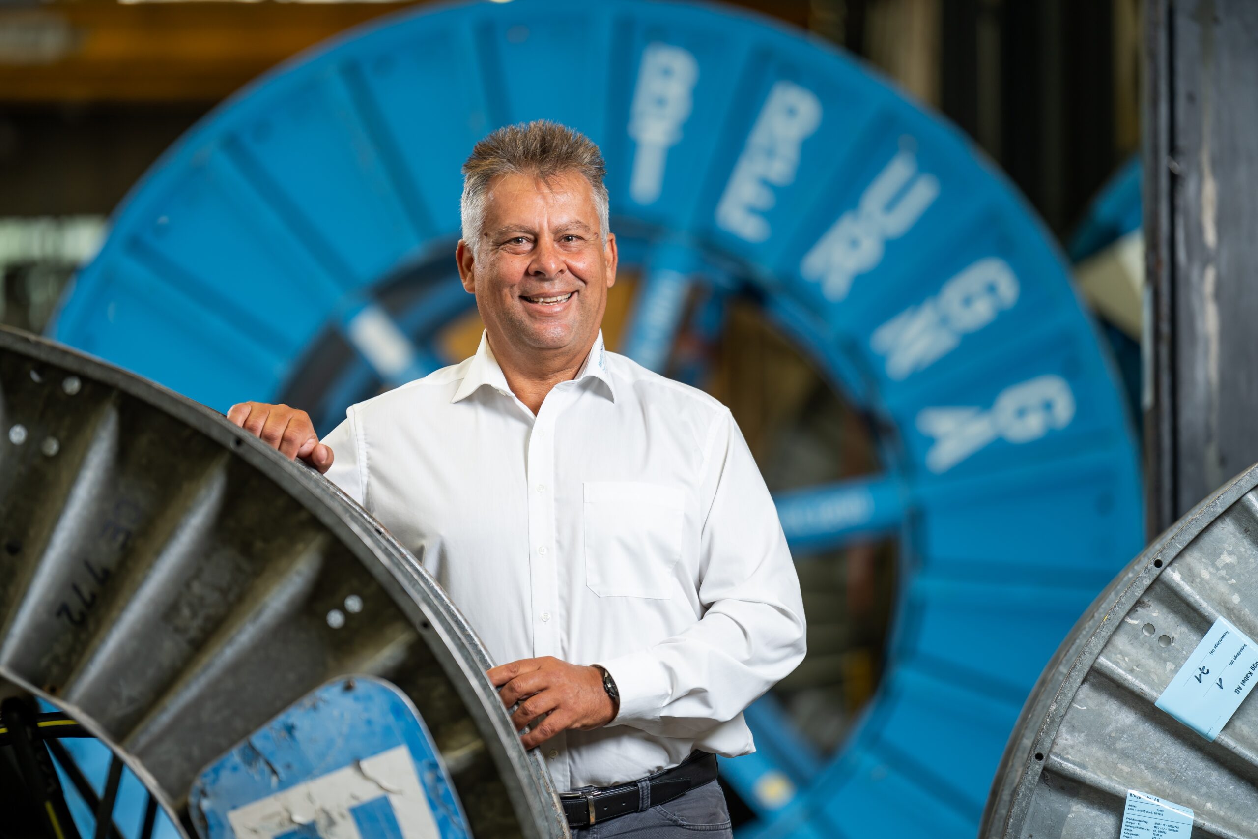 Brugg Cables employee near cable reels, highlighting career opportunities in the company.
