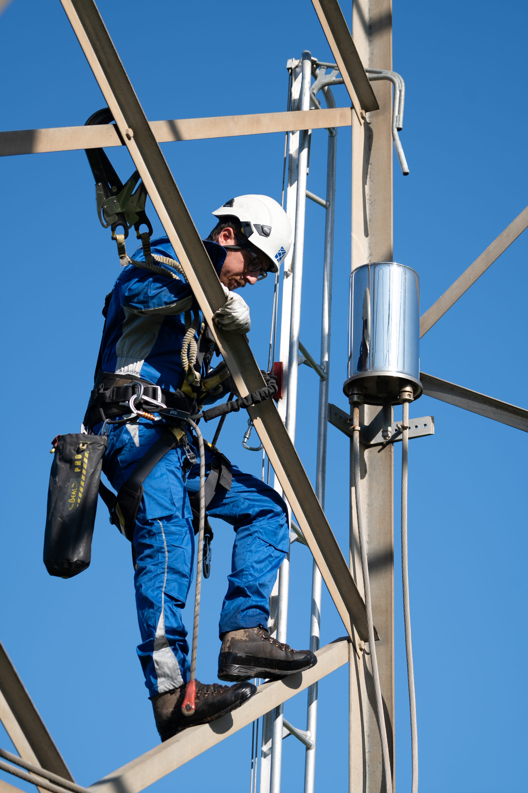 Technician installing high-voltage cable infrastructure for Brugg Cables