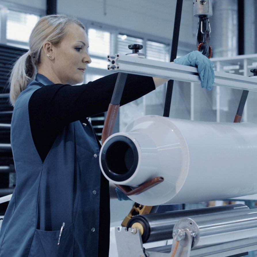 Brugg Cables employee working on production equipment, highlighting career opportunities.
