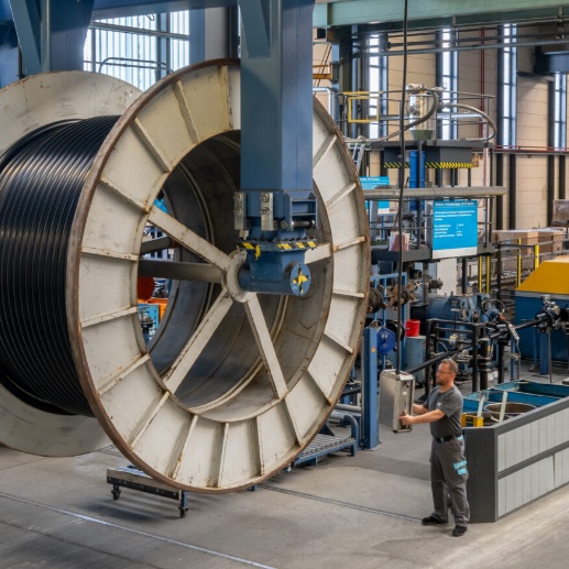 Brugg Cables large cable reel handled in industrial production hall with lifting system