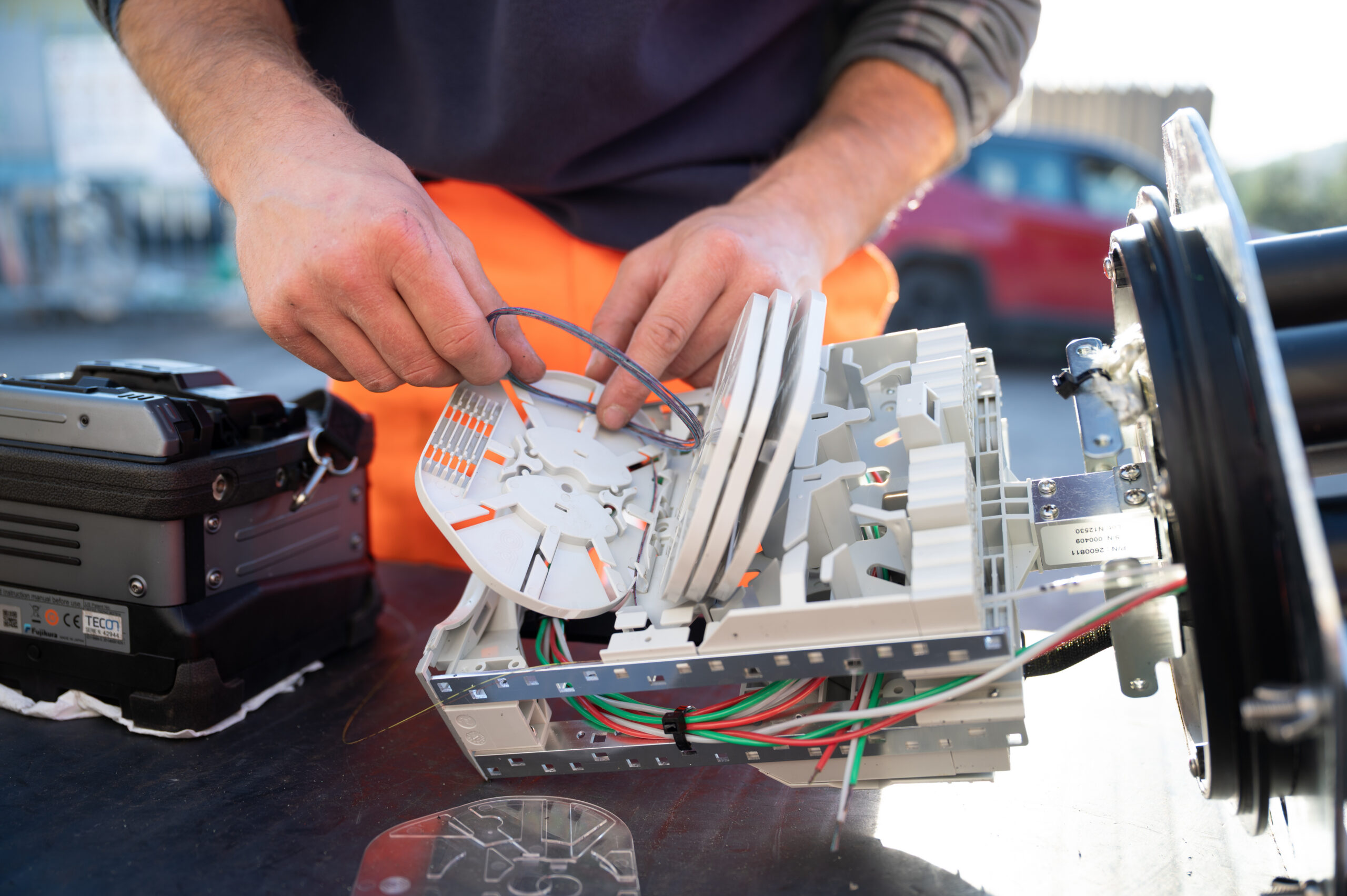 Technician working on cable connection components during a Brugg Cables infrastructure installation