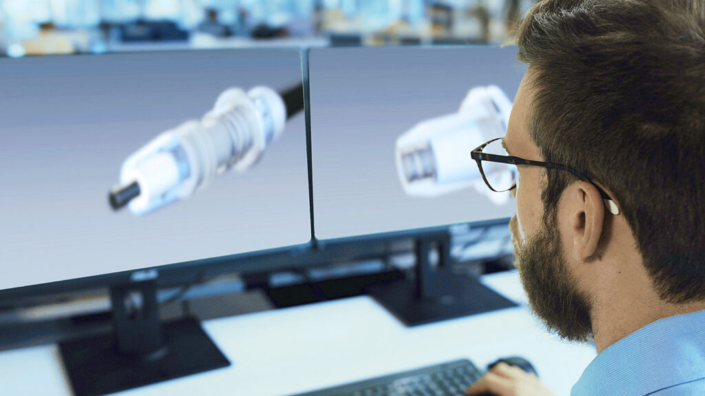 Engineer reviewing cable component design for high voltage testing in an advanced testing laboratory